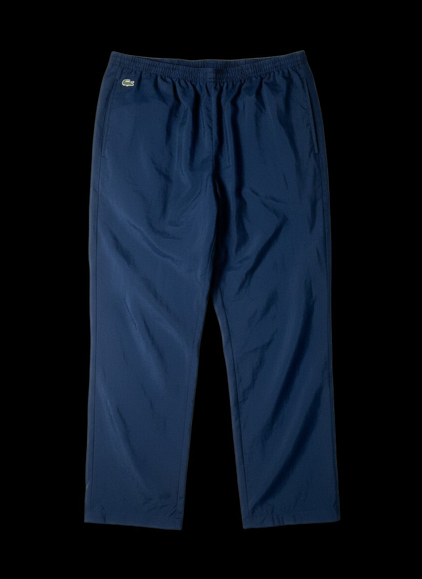 Calça vintage azul marinho da Lacoste dos anos 90, tamanho GG, com zíper na barra.