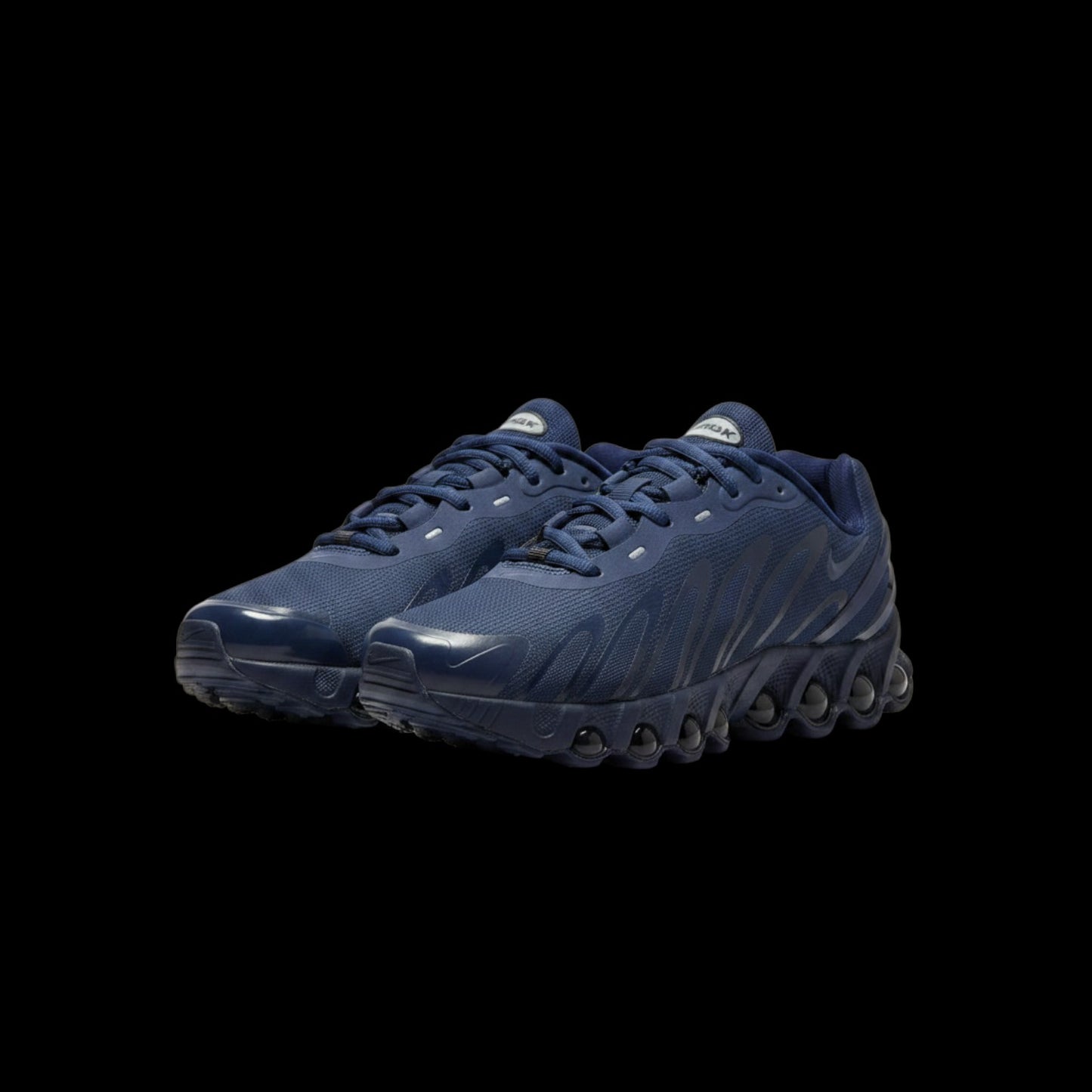 Tênis Nike Air Max Dn8 azul marinho com detalhes em cinza, solado com bolhas de ar e logo Nike.