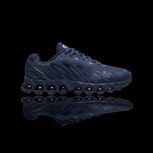 Tênis Nike Air Max Dn8 azul marinho com solado de bolhas e swoosh lateral prateado.